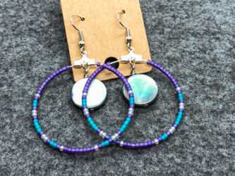 Multicolor hoop earrings with natural shell accent beads. Multicolor hoop earrings with natural shell accent beads.