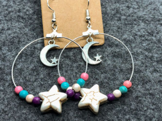 Pastel beaded earrings with central white star bead with a dangling center moon and star charm Pastel beaded earrings with central white star bead with a dangling center moon and star charm